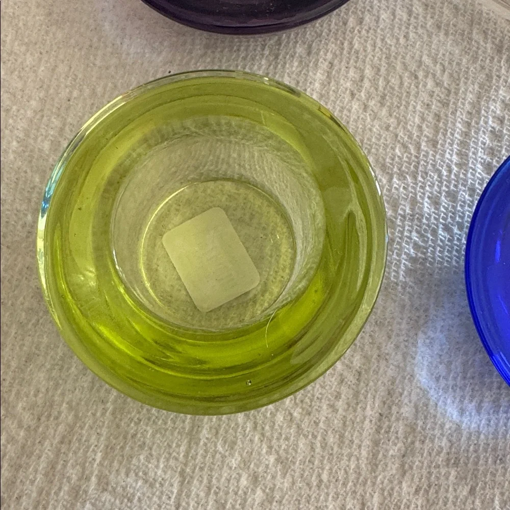 Crate & Barrel set of 4 multicolored tealights cobalt, clear, purple, lime.